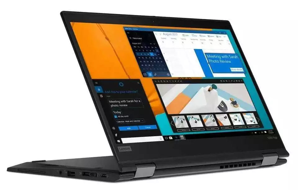 Lenovo ThinkPad X390 Yoga laptop in convertible mode displaying Windows 11 interface and creative design software.